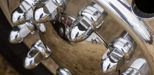 A closeup shot of a shiny metal hub of a car